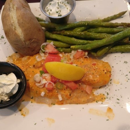 White fish baked and topped with our signature roasted red pepper cream sauce, tomatoes and scallions. Served with choice of two sides.